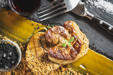 Fried Foie Gras with Mango Puree on Dark Background. Goose Liver. © Victority