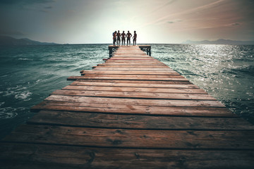 Naklejka premium A group of triathlon athletes on the pier after training