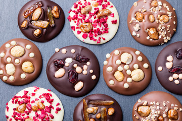 Luxury handmade chocolate mediants, cookies, bites, candies. Traditional french dessert. Slate...