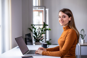 Side portrait of a beautiful young woman at work