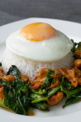 Fried Chinese kale with crispy skin chicken in oyster sauce and chilli in the white dish, fried egg, rice.