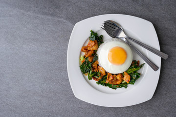Fried Chinese kale with crispy skin chicken in oyster sauce and chilli in the white dish, fried egg, rice.
