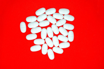 white pills on a red background - 267982411