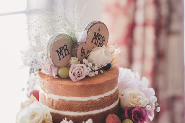 Naked wedding cake with fruit and flowers