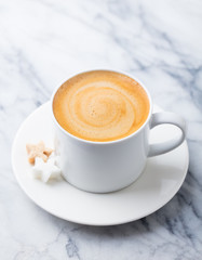 Coffee, espresso in white cup of marble table background.