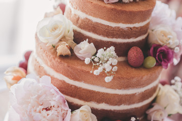 Naked wedding cake with fruit and flowers