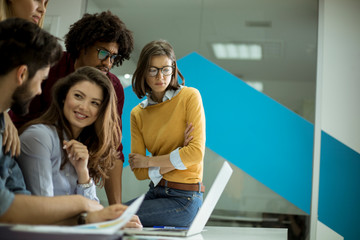 Group of young multiethnic business people working and communicating together in creative office