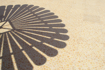 Shades from the beach umbrella by the pool in hotel. Copy space. Summer concept.
