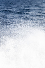 Fototapeta na wymiar Water splash on the blue sea