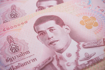 Close up King Maha Vajiralongkorn Bodindradebayavarangkun (Rama 10) on 100 baht Thai banknotes bill texture background. Concept of Thai baht payment currency of Thailand, Forex investment