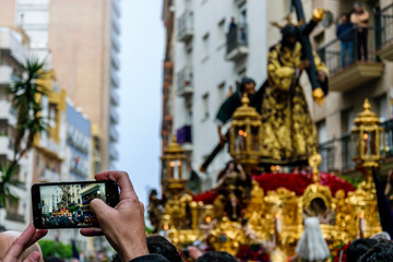 A man photographs with his mobile phone the Procession of Jesus the Nazarene in Huelva, Spain.