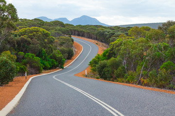 Natural scenery on the open road in Australian Outback.  Freedom and orange red road.