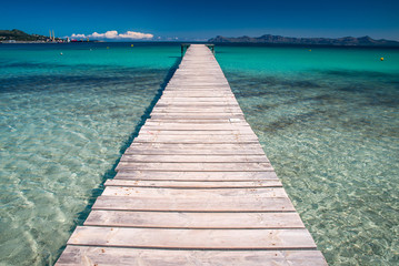 Pier on beautiful summer tropical beach. Holidays concept photo. Mallorca, Spain