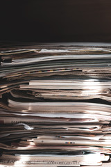 Pile of old newspapers and magazines, stack, side view.  Vintage background