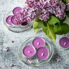 Obraz na płótnie Canvas Small round decorative candles with a aroma flowers lilac on a blue background. Selective focus.
