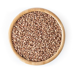 Roasted buckwheat grains in wooden bowl isolated on white background with clipping path