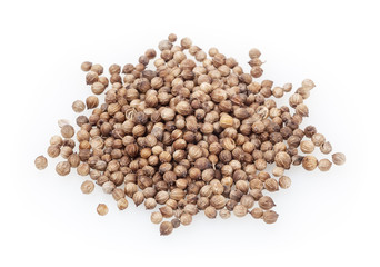 Heap of dried coriander seeds isolated on white background