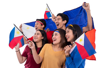 filipino group of people holding philippines flag celebrating independence day