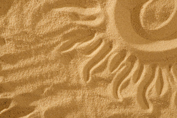 Fototapeta na wymiar Sun on sand on beach holiday background concept