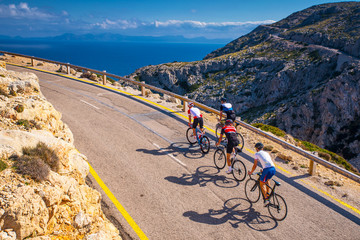 Road bikers on the road on Balearic Islands. Sea in Background. Cap de Formentor. Mallorca,...