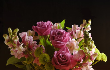 Closeup of a beautiful floral arrangement for Mothers Day or Valentines on a black background