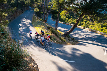 Group of triathletes on road bicycle, sport photo in nature. Majorca, Spain