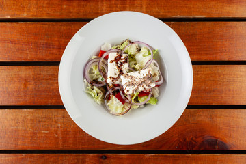 Fresh greek salad with feta on the table
