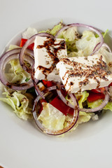 Greek salad on a white plate