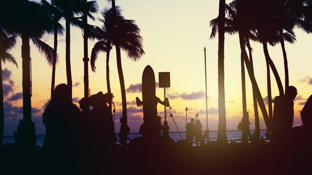 Tourists walking at sunset in Waikiki beach in 4k slow motion 60fps