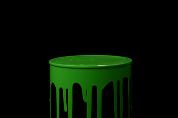 Green paint flowing over the wall of metal bucket. Isolated