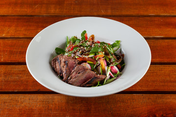 Top-view salad with medium rare beef steak