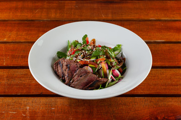 Top-view salad with medium rare beef steak