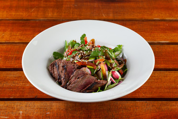 Top-view salad with medium rare beef steak