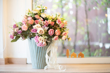 Artificial Flowers in white vase as background
