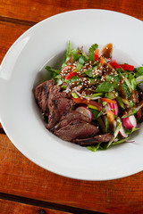 Top-view salad with medium rare beef steak
