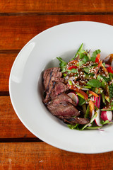 Top-view salad with medium rare beef steak