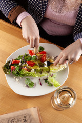 Eating out healthy salad with female hands