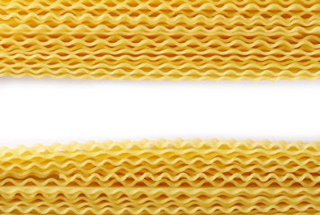 Uncooked Italian pasta mafaldine isolated on white background, top view