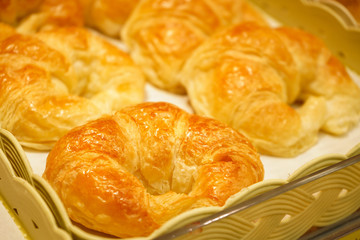 Croissants look delicious in serving trays.