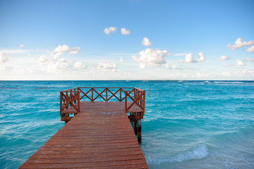 Wooden pier on the shores of the Caribbean Sea in the city of Cancun.