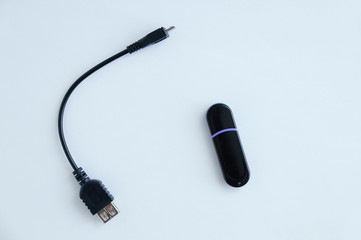 Cable otg for smartphone and flash drive. White background.