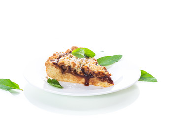 sweet cake with fruit jam in a plate on a white