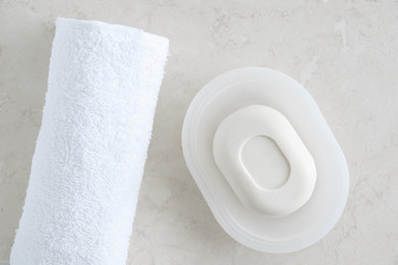 Terry towel and soap. On a marble background.