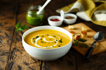 Homemade pumpkin soup with pesto sauce