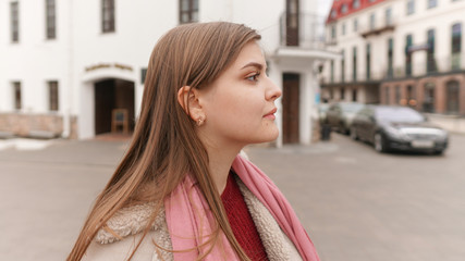 Closeup of a beautiful happy woman on a outdoors city street background