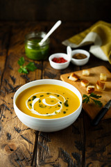 Homemade pumpkin soup with pesto sauce