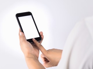 The woman's hand is holding the phone in his hand. The phone has a white screen.