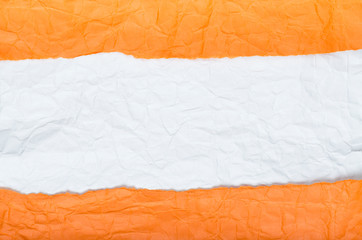Background of strips of crumpled paper orange white