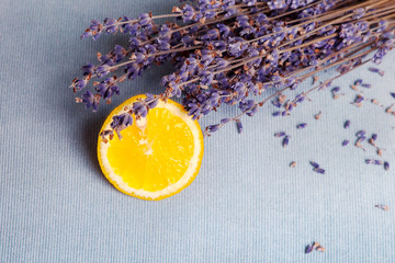 Fresh lemon with lavender on blue background