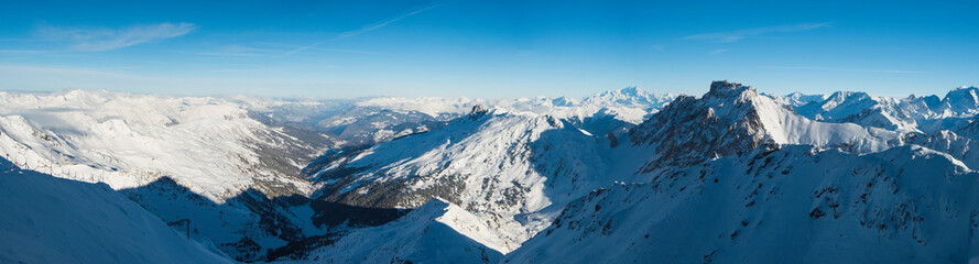 Panoramic view across snow covered alpine mountain range
